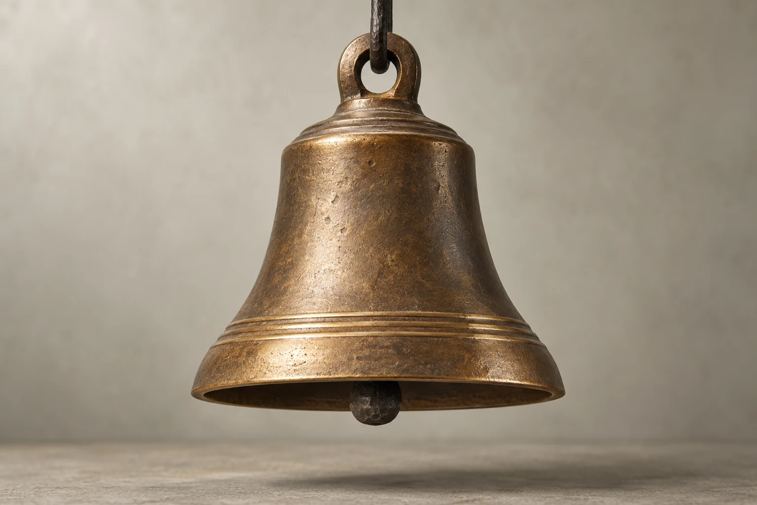 Sand-cast bronze bell with a polished soundbow and forged iron clapper